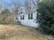 Single-story home with white siding and dark shutters surrounded by trees at 282 Dixon Rd, Lancaster, SC 29720