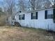 Modest single-story home with white siding and dark shutters, set against a backdrop of trees at 282 Dixon Rd, Lancaster, SC 29720