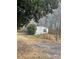 Single-story home with white siding and dark shutters, set against a backdrop of trees at 282 Dixon Rd, Lancaster, SC 29720