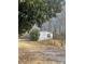 Single-story home with white siding and dark shutters, set against a backdrop of trees at 282 Dixon Rd, Lancaster, SC 29720