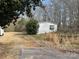 Modest single-story home with white siding, set against a backdrop of trees at 282 Dixon Rd, Lancaster, SC 29720