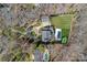 Aerial view of a stunning estate with mature trees, circular driveway, and a backyard pool and green space at 3212 Lazy Branch Rd, Charlotte, NC 28270