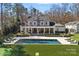 An elegant pool is surrounded by lounge chairs on lush green lawn at 3212 Lazy Branch Rd, Charlotte, NC 28270