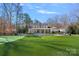 Spacious backyard with a pool, lush lawn, and covered patio, ideal for outdoor gatherings and enjoyment at 3212 Lazy Branch Rd, Charlotte, NC 28270