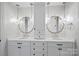 Elegant bathroom featuring double vanities, stylish mirrors, and pendant lighting at 3212 Lazy Branch Rd, Charlotte, NC 28270