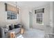 Bathroom features a cozy sitting area, natural light, and a modern glass-enclosed shower at 3212 Lazy Branch Rd, Charlotte, NC 28270