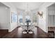 Sunlit dining area with modern chandelier and large windows, plus access to butler's pantry at 3212 Lazy Branch Rd, Charlotte, NC 28270