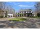 Beautiful brick home with circular driveway and lush lawn showcasing mature trees and detached garage at 3212 Lazy Branch Rd, Charlotte, NC 28270