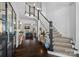 Grand foyer with hardwood floors, staircase, and views of the living room with cozy fireplace at 3212 Lazy Branch Rd, Charlotte, NC 28270