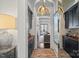 Hallway features brick flooring, dark cabinets, and view into the living room at 3212 Lazy Branch Rd, Charlotte, NC 28270