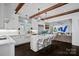 Spacious white kitchen with a large island, stainless steel appliances, and views into the living area at 3212 Lazy Branch Rd, Charlotte, NC 28270