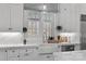 Bright kitchen with white cabinetry, marble countertops, and farmhouse sink beneath the window at 3212 Lazy Branch Rd, Charlotte, NC 28270