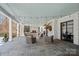 Large outdoor patio with stone flooring, fireplace, and comfortable seating arrangements at 3212 Lazy Branch Rd, Charlotte, NC 28270