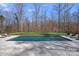 Inviting pool area with a large pool, stone patio, and a beautifully maintained lawn, perfect for relaxation at 3212 Lazy Branch Rd, Charlotte, NC 28270