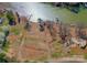 Lakefront lot ready for new home construction with an in-progress foundation, nestled along a tranquil waterfront with private dock at 324 Bridgewater Ln, Mooresville, NC 28117