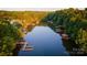 Aerial view of a tranquil lake lined with trees, featuring multiple boat docks and waterfront properties at 324 Bridgewater Ln, Mooresville, NC 28117