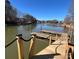 Brand new dock offering serene water views with clear blue skies, and wooden posts with black rope railing at 324 Bridgewater Ln, Mooresville, NC 28117