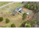 Aerial shot of the house with a long driveway, expansive yard, shed and treed perimeter at 3929 Wexford Ln, Denver, NC 28037