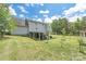 Backyard features lush green grass, a covered patio, the exterior of the house, and a wooden fence at 3929 Wexford Ln, Denver, NC 28037