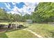 Expansive backyard with a shed, patio, outdoor kitchen, furniture, and stone path at 3929 Wexford Ln, Denver, NC 28037