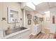 Cozy bathroom featuring neutral walls, mirrors, a sink, and wood-look floors at 3929 Wexford Ln, Denver, NC 28037