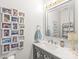 Well-lit bathroom with a modern vanity, framed mirror, and decorative accents at 3929 Wexford Ln, Denver, NC 28037