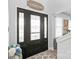 Inviting foyer with a decorative front door, elegant lighting, and neutral color palette at 3929 Wexford Ln, Denver, NC 28037