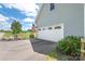 Garage with white doors, an American flag, and landscaped yard for added curb appeal on a sunny day at 3929 Wexford Ln, Denver, NC 28037