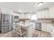 Bright kitchen with white cabinets, granite countertops, stainless steel appliances, and center island at 3929 Wexford Ln, Denver, NC 28037