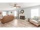 Cozy living room with a fireplace, ceiling fan, neutral decor, and comfortable seating at 3929 Wexford Ln, Denver, NC 28037