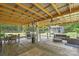 Covered porch with outdoor dining, seating, grill, and bar area for entertaining while enjoying the property's spacious outdoor living at 3929 Wexford Ln, Denver, NC 28037