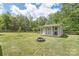 Backyard shed features a covered porch, fire pit, and is surrounded by a wooden fence at 3929 Wexford Ln, Denver, NC 28037