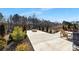 Backyard view of firepit with a well-maintained lawn and mature trees at 4253 Spadefoot Ct, Lancaster, SC 29720