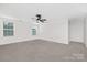 Large, unfurnished bedroom with carpet, ceiling fan, and two large windows at 4253 Spadefoot Ct, Lancaster, SC 29720