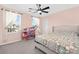 Bright bedroom with a patterned quilt, ceiling fan, and a charming toy shelf at 4253 Spadefoot Ct, Lancaster, SC 29720