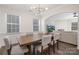 Formal dining room with wainscoting, modern lighting fixture, and archway to the living room at 4253 Spadefoot Ct, Lancaster, SC 29720