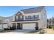 Charming two-story home featuring brick accents, a spacious two-car garage, and manicured landscaping at 4253 Spadefoot Ct, Lancaster, SC 29720