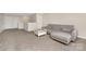 Spacious living room with neutral walls, carpet, a gray sofa, and white doors at 4253 Spadefoot Ct, Lancaster, SC 29720