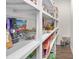 Walk-in pantry with white shelving stocked with various food items and supplies at 4253 Spadefoot Ct, Lancaster, SC 29720