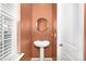 Stylish powder room with a pedestal sink, round mirror, and modern fixtures at 4253 Spadefoot Ct, Lancaster, SC 29720