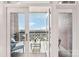 Inviting covered brick balcony with comfortable seating, a coffee table, and views of the surroundings through white framed doors at 572 N Church St, Charlotte, NC 28202