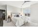 Bright primary bedroom with a gray upholstered headboard, white linens, and a large window at 572 N Church St, Charlotte, NC 28202