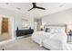 Primary bedroom with white linens, gray headboard, dark console, and ensuite bathroom at 572 N Church St, Charlotte, NC 28202