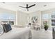 Bright bedroom with a ceiling fan, large windows, a fluffy white comforter, and neutral décor at 572 N Church St, Charlotte, NC 28202