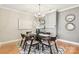 Elegant dining room with modern chandelier and seating for six at 572 N Church St, Charlotte, NC 28202