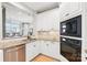 Kitchen featuring stainless steel appliances, stone counters, and a view into the living room at 572 N Church St, Charlotte, NC 28202