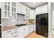 White kitchen cabinets, granite countertops, and modern appliances at 572 N Church St, Charlotte, NC 28202