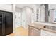 Bright kitchen featuring granite countertops, stainless steel dishwasher, and access to laundry room and other living areas at 572 N Church St, Charlotte, NC 28202