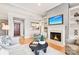 Stylish living room featuring a fireplace, hardwood floors, and a view into the kitchen at 572 N Church St, Charlotte, NC 28202
