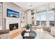 Living room with a fireplace, built-in shelving, and a large window overlooking a balcony at 572 N Church St, Charlotte, NC 28202